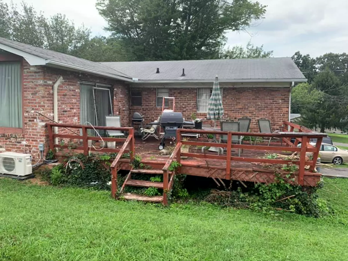 Brick house with old, warped deck