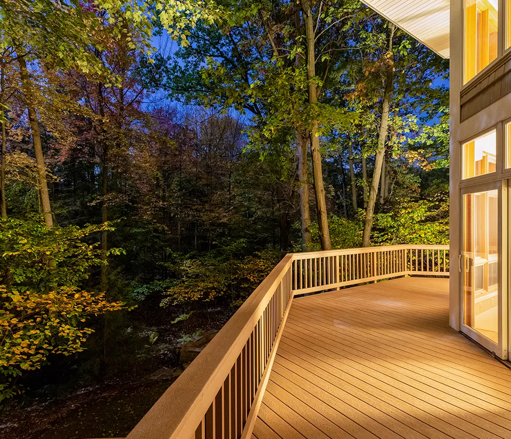 Composite deck surrounding a house in Tennessee, with view of forest
